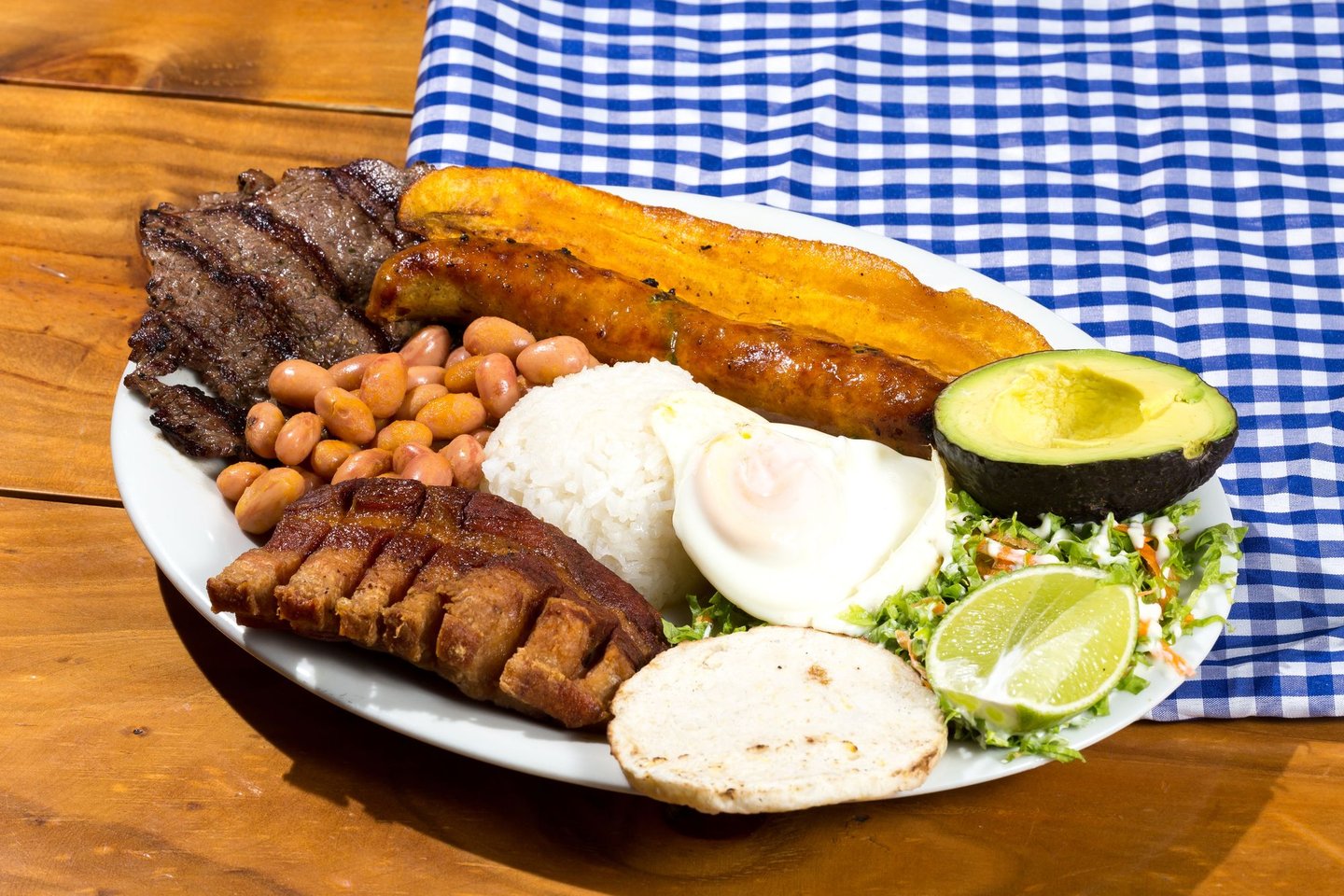 Bandeja Paisa with plantain, meat, beans, rice and avocado