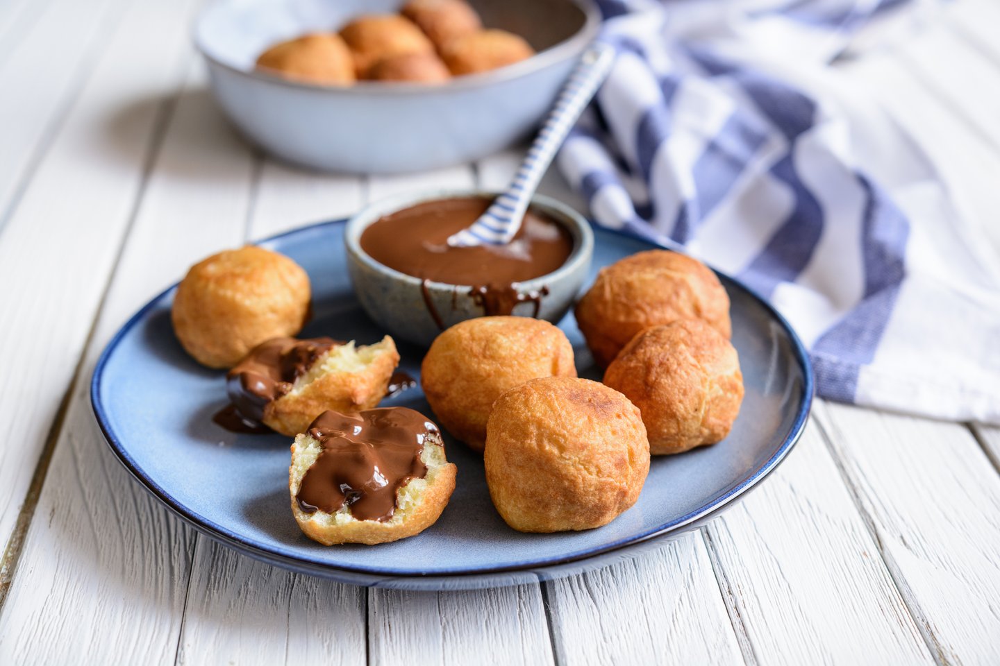 Bunuelos, traditional Colombian sweet deep fried pastry served with chocolate sauce