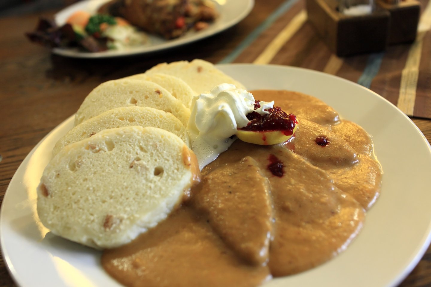 A plate of goulash and Czech bread dumplings