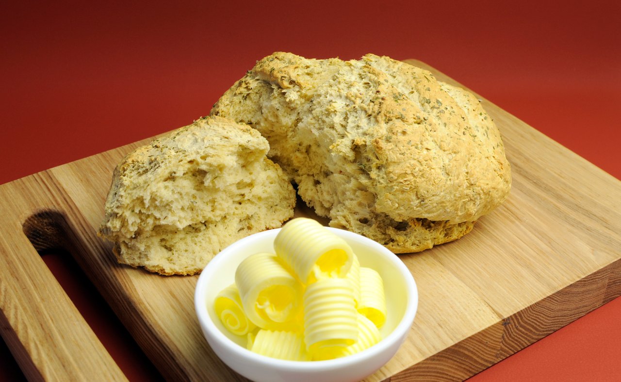 Damper bread on a board with butter