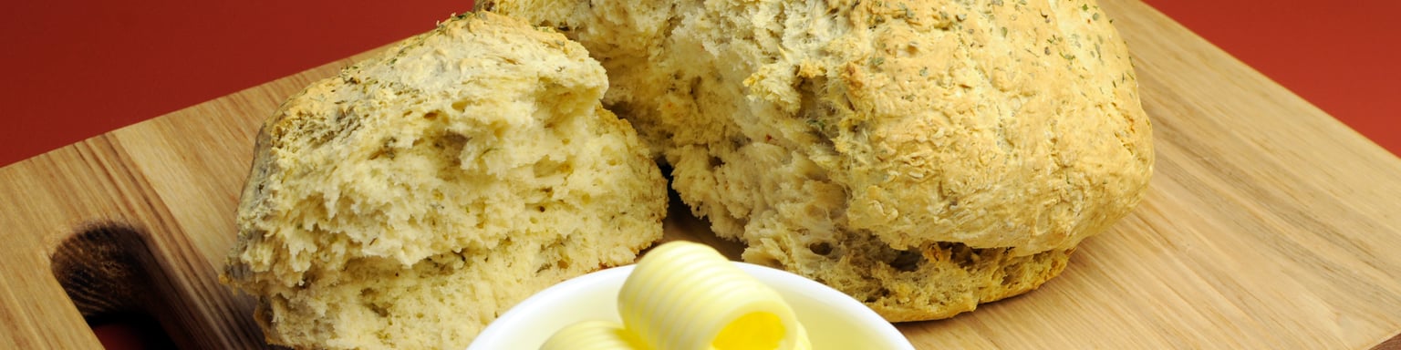 Damper bread on a board with butter