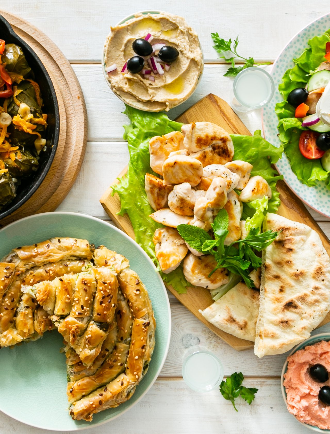 A spread of traditional Greek food on a wooden table