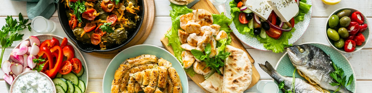 A spread of traditional Greek food on a wooden table