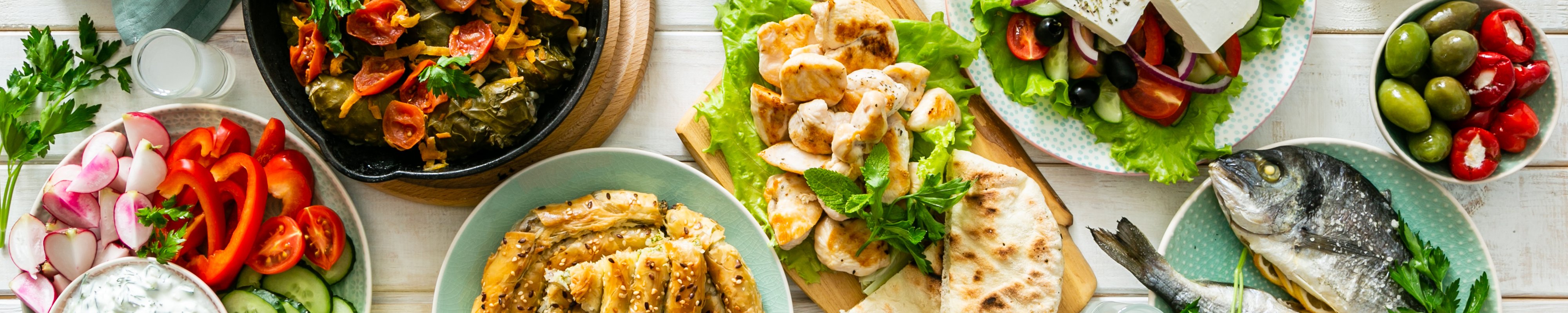 A spread of traditional Greek food on a wooden table