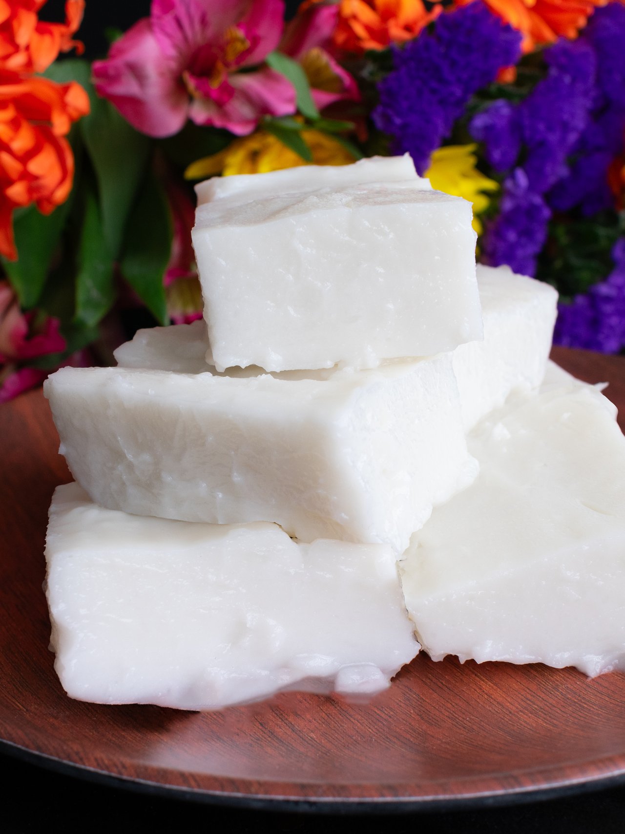 Haupia squares on a wooden plate.