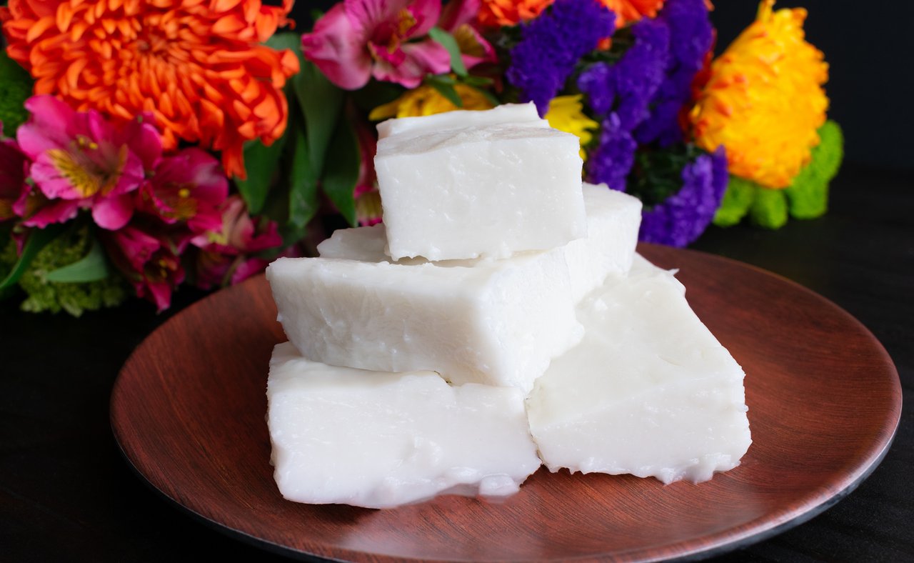 Haupia squares on a wooden plate.