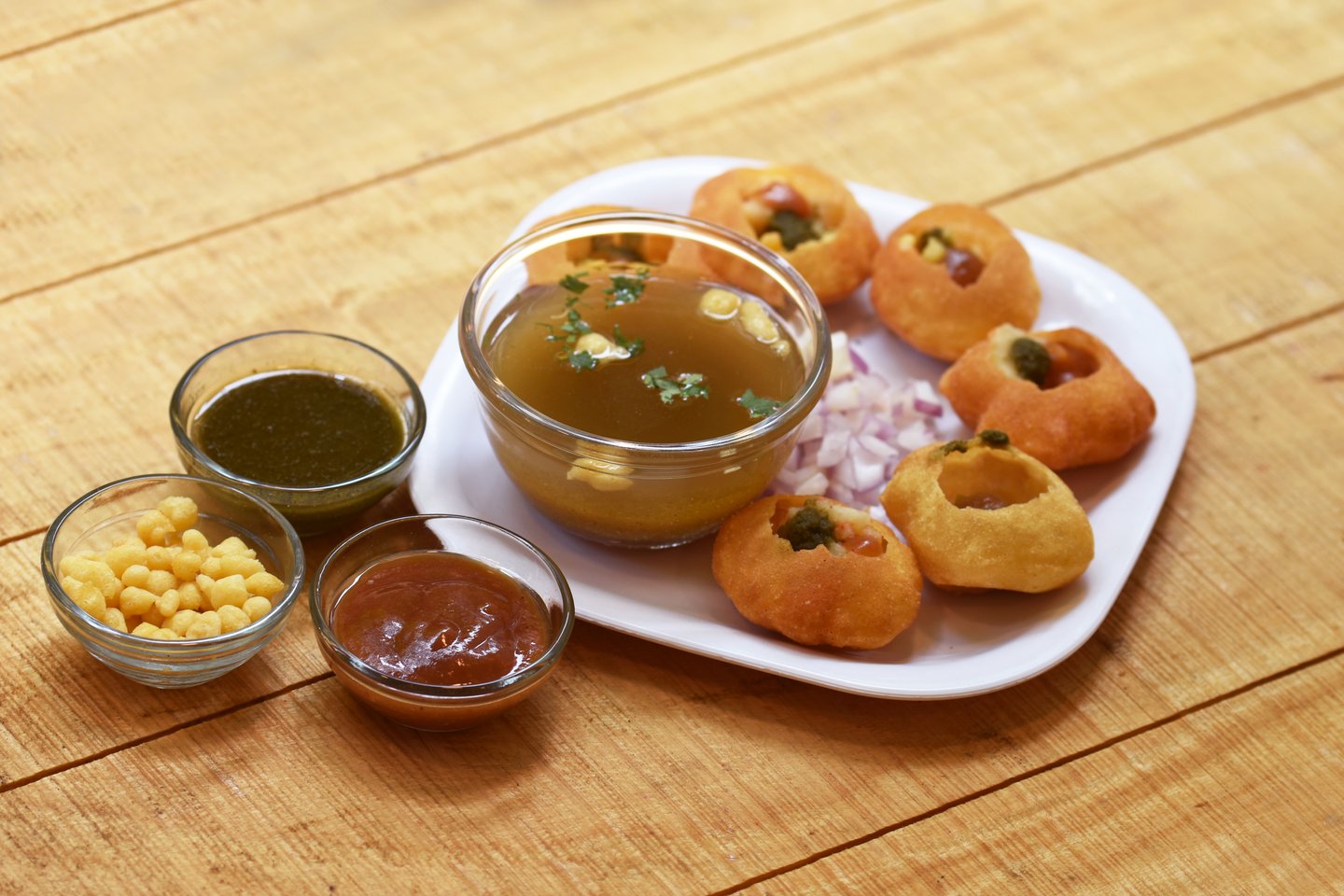 A plate of gol gappa (also known as panipuri) with dipping sauces