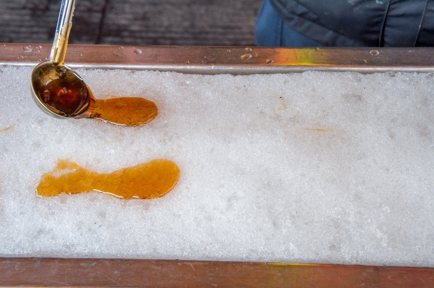Spooning the thick syrup onto snow