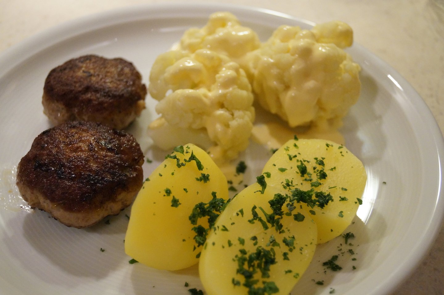 Meatballs served with boiled potatoes and cauliflower