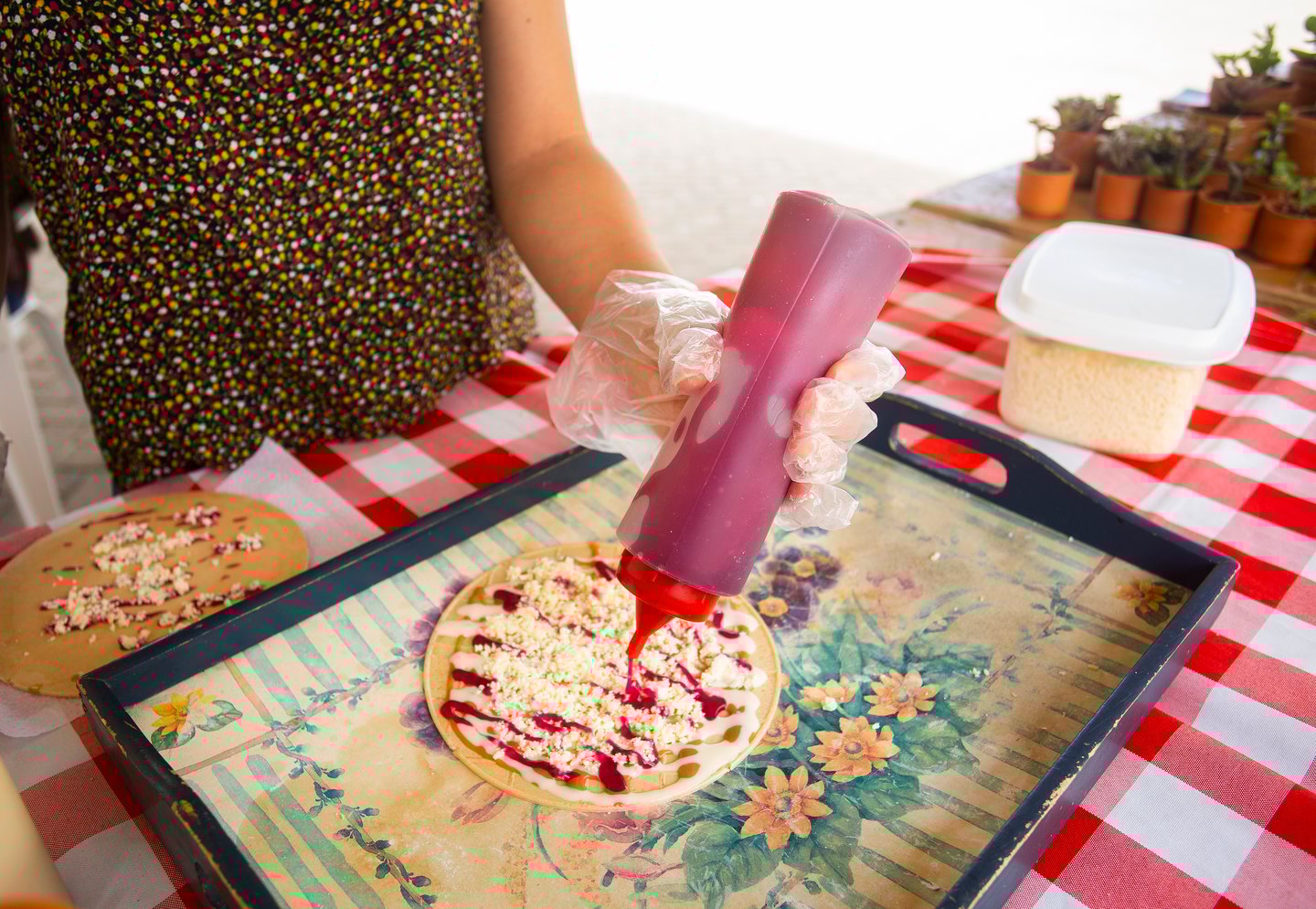 A woman preparing Obleas, a sweet Colombian wafer