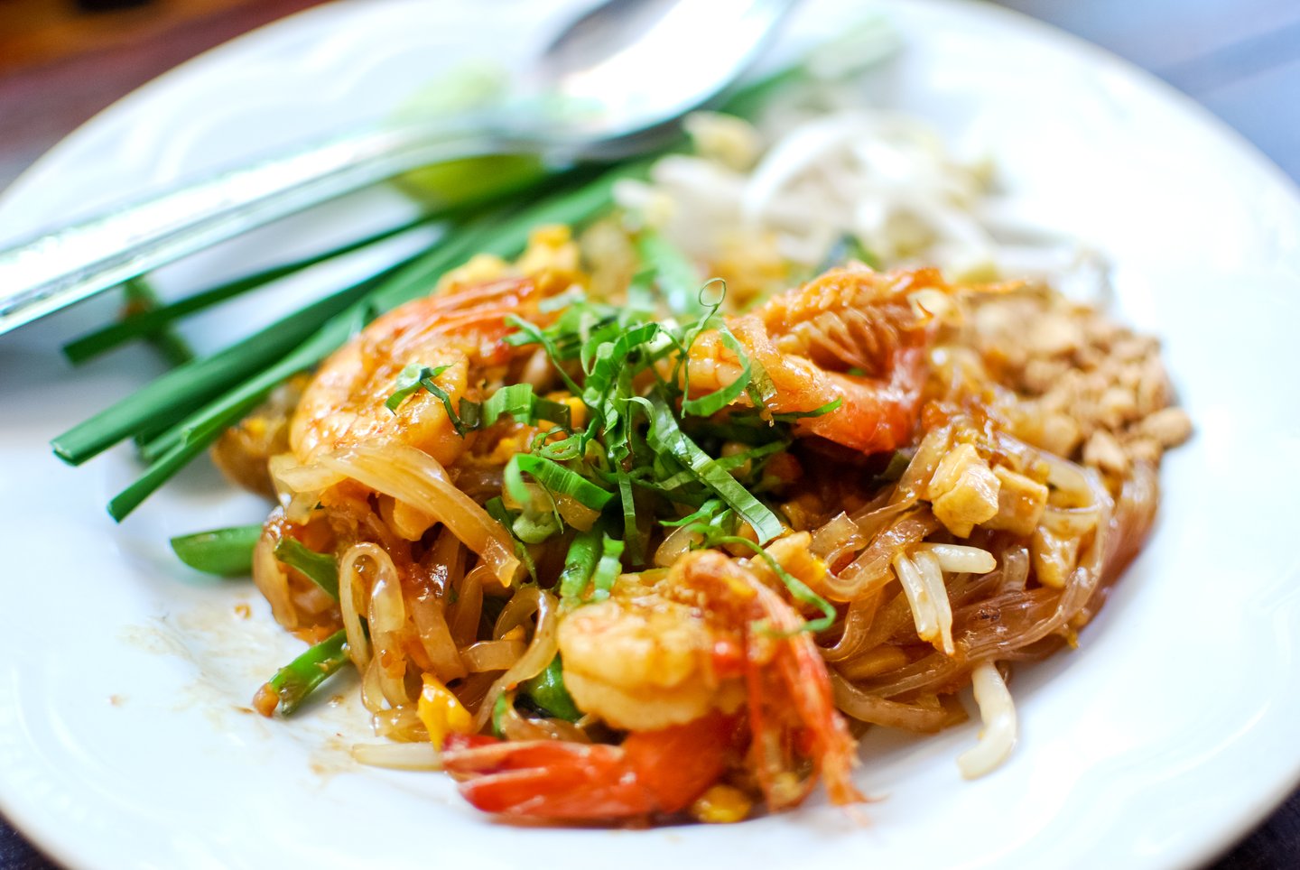 A dish of Pad Thai topped with prawns