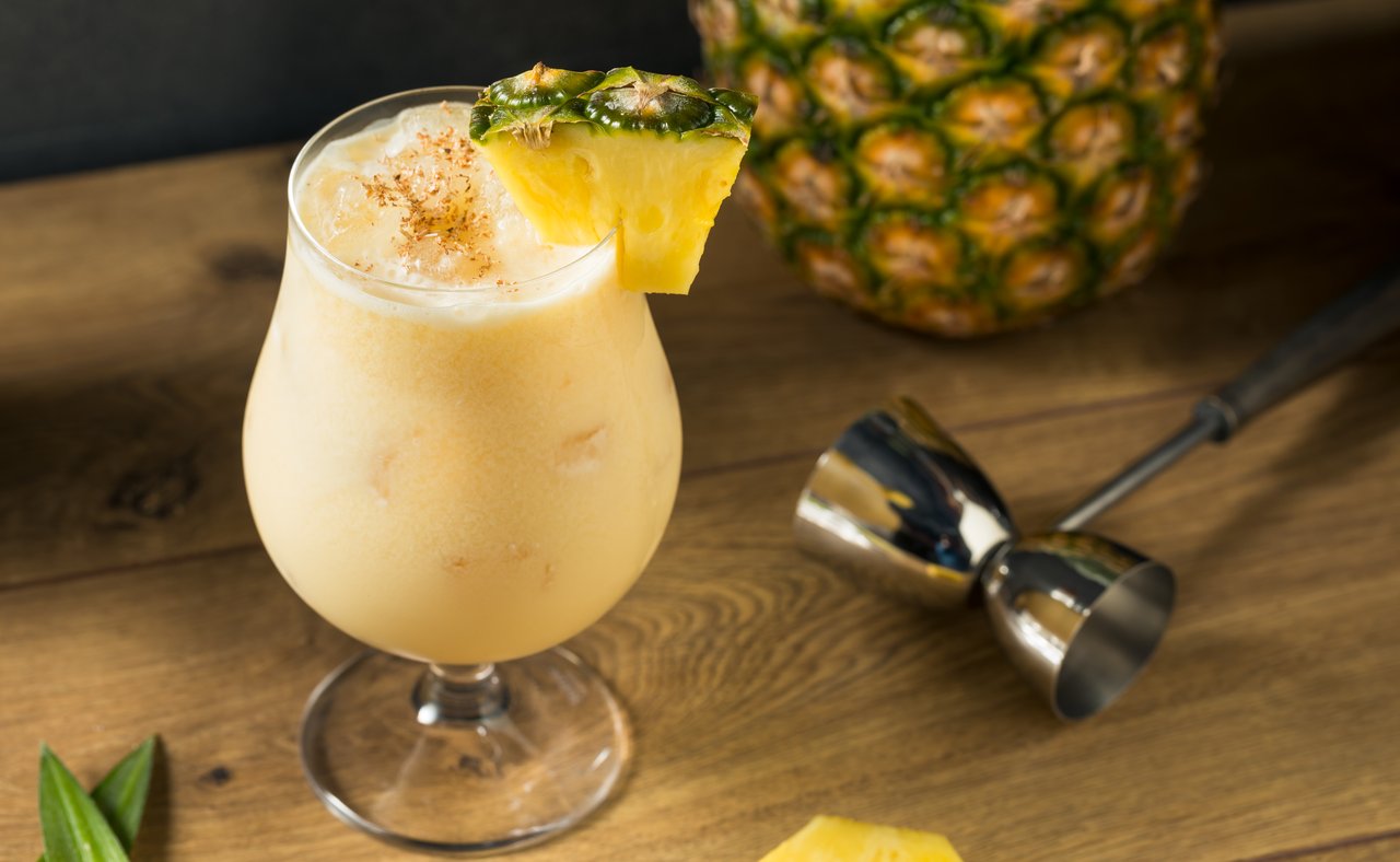 The painkiller cocktail garnished with a pineapple wedge