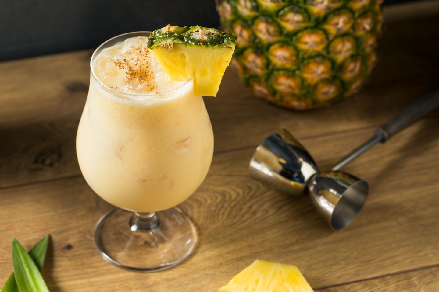 The painkiller cocktail garnished with a pineapple wedge