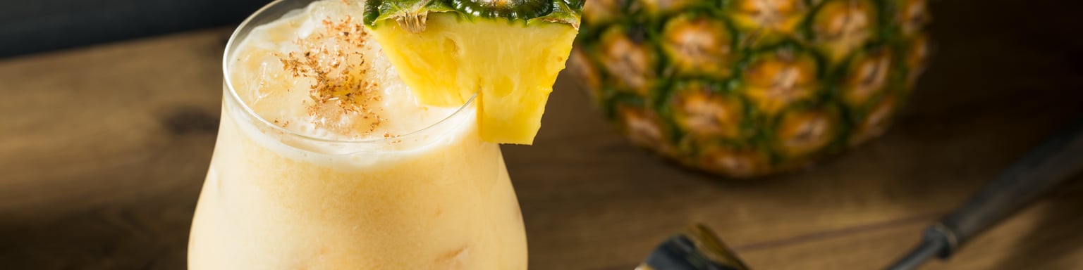 The painkiller cocktail garnished with a pineapple wedge