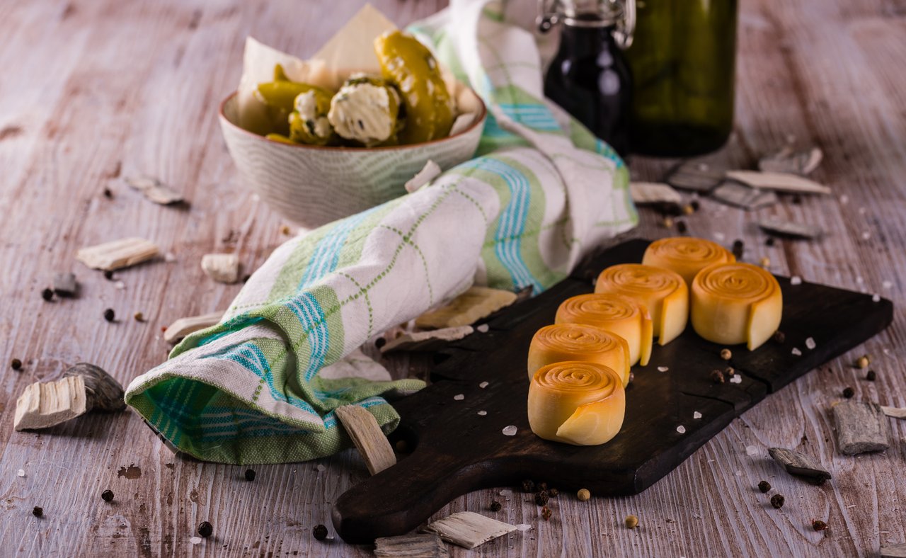 Rolls of parenica cheese on a chopping board