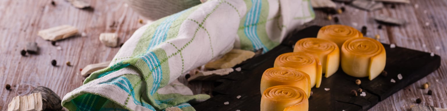 Rolls of parenica cheese on a chopping board