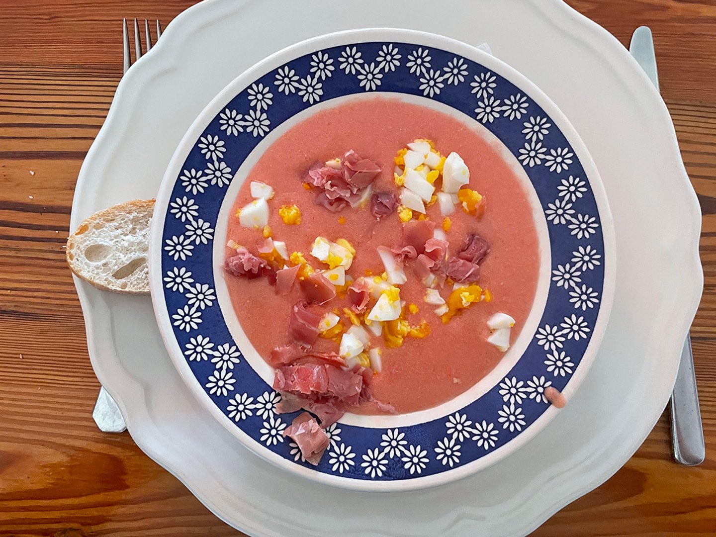 A bowl of salmorego soup garnished with egg and ham