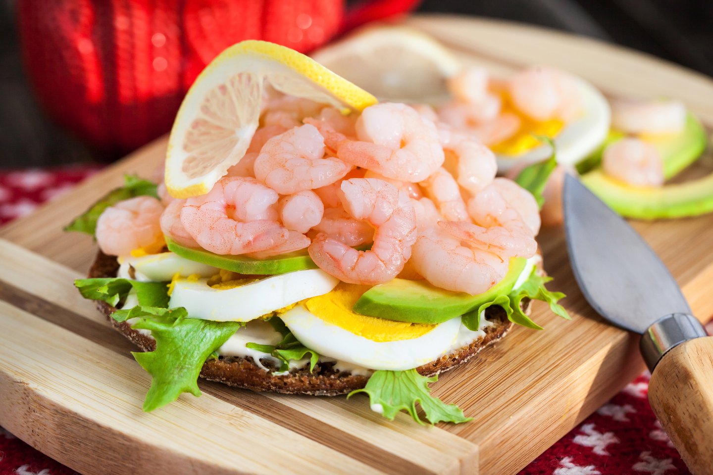 A Swedish open shrimp sandwich with lettuce, egg and avocado