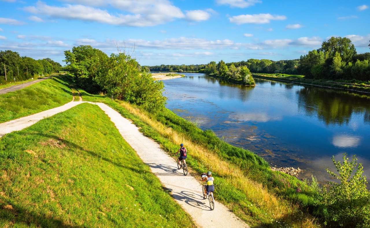 People cycling along the Loire River in Chatilllon sur Loire, France.