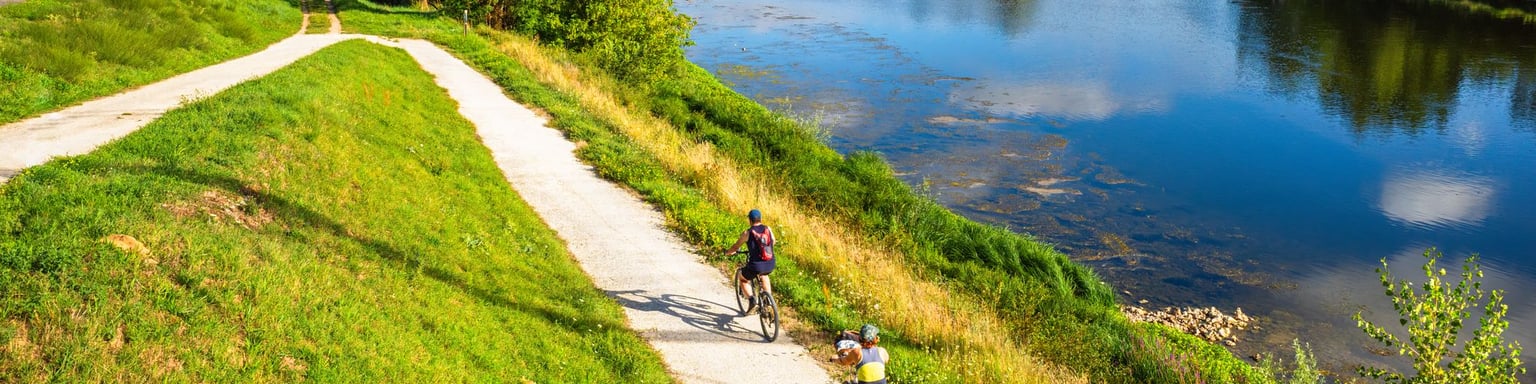 People cycling along the Loire River in Chatilllon sur Loire, France.
