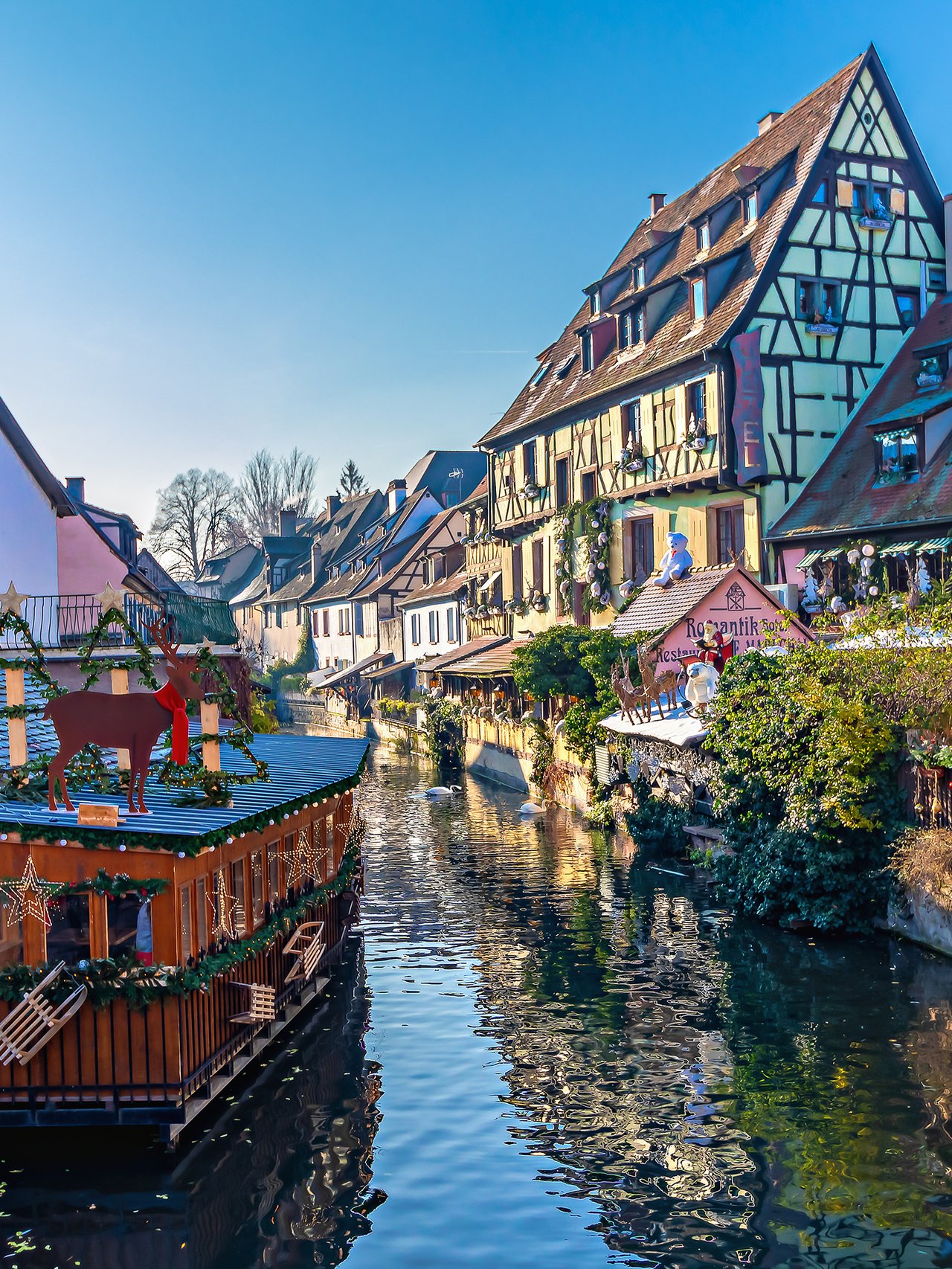Houses along a canal in Colmar decorated for Christmas