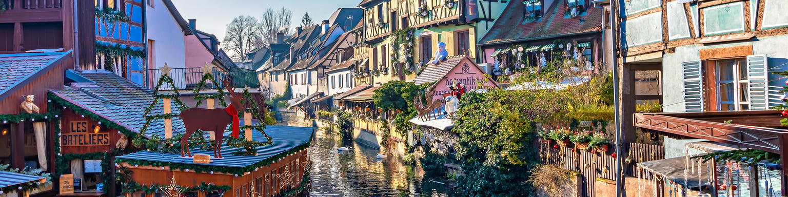 Houses along a canal in Colmar decorated for Christmas