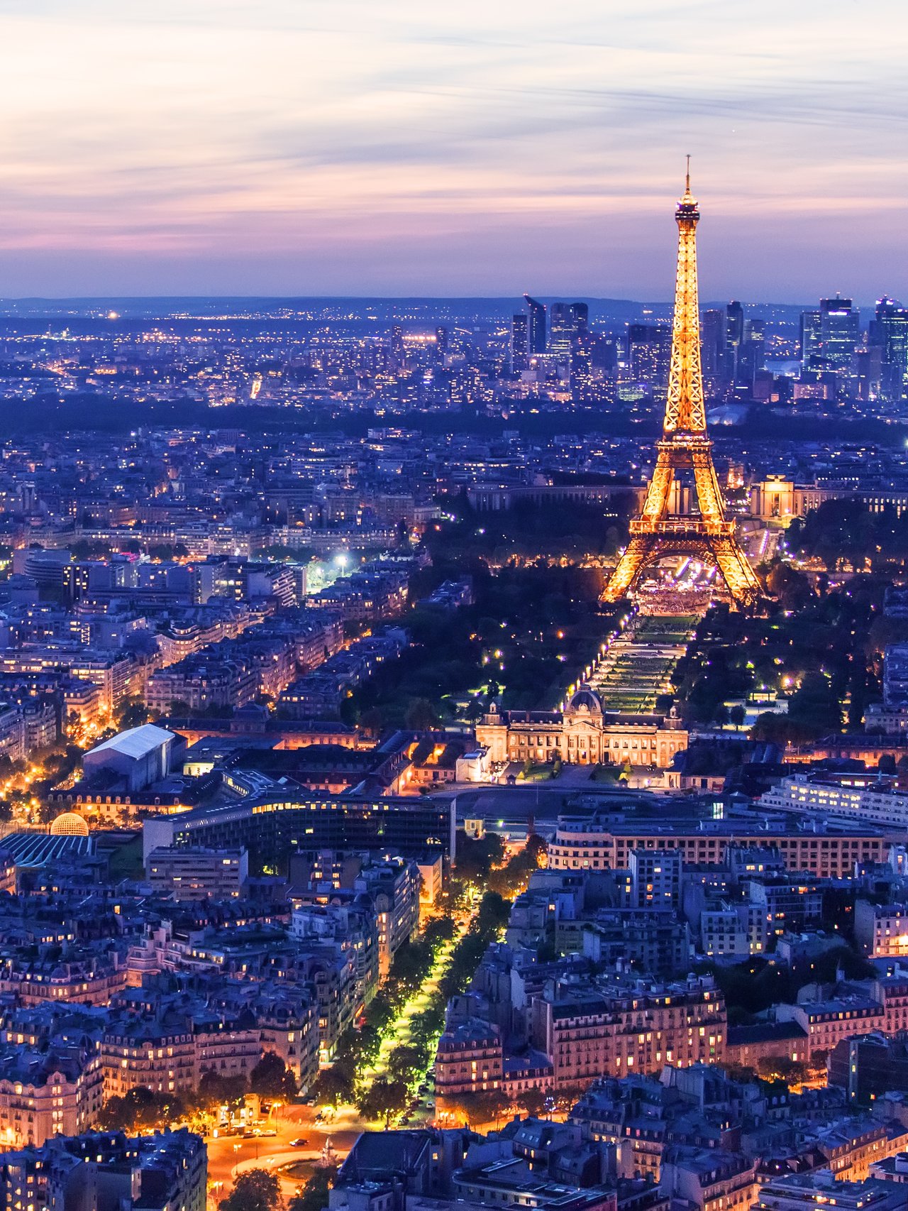 The illuminated Eiffel Tower at night in Paris, France.