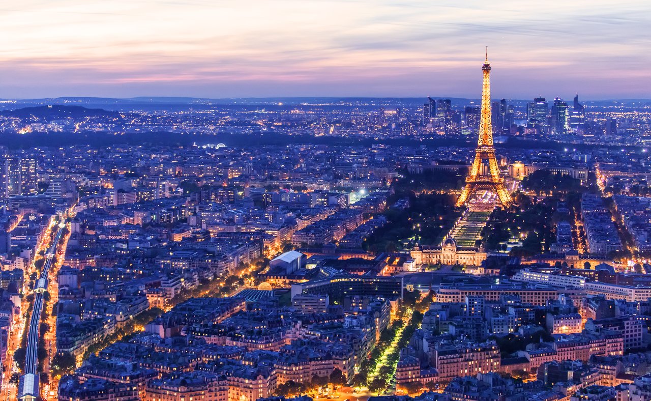 The illuminated Eiffel Tower at night in Paris, France.