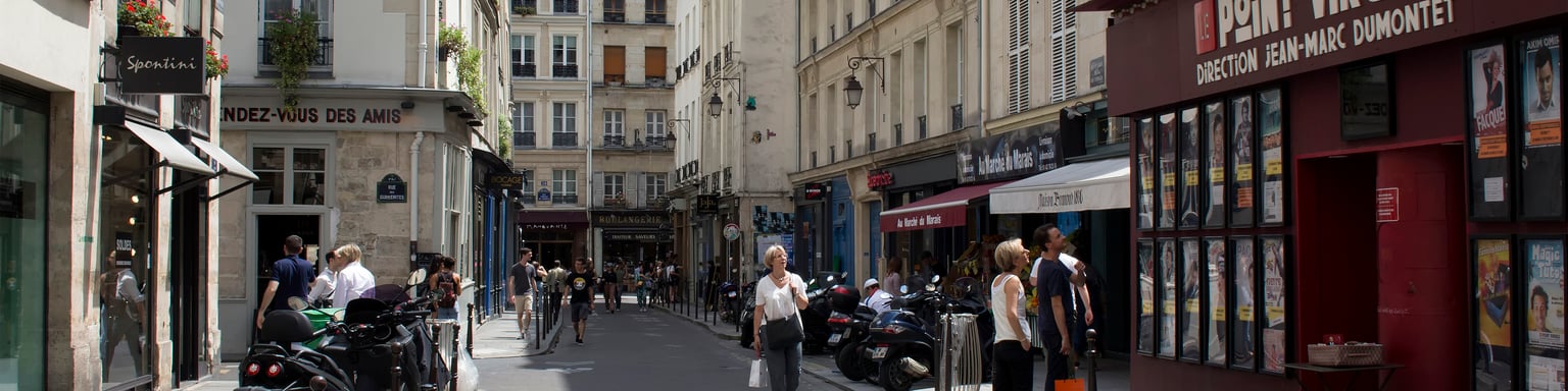People walk on one of streets of Le Marais district of Paris.