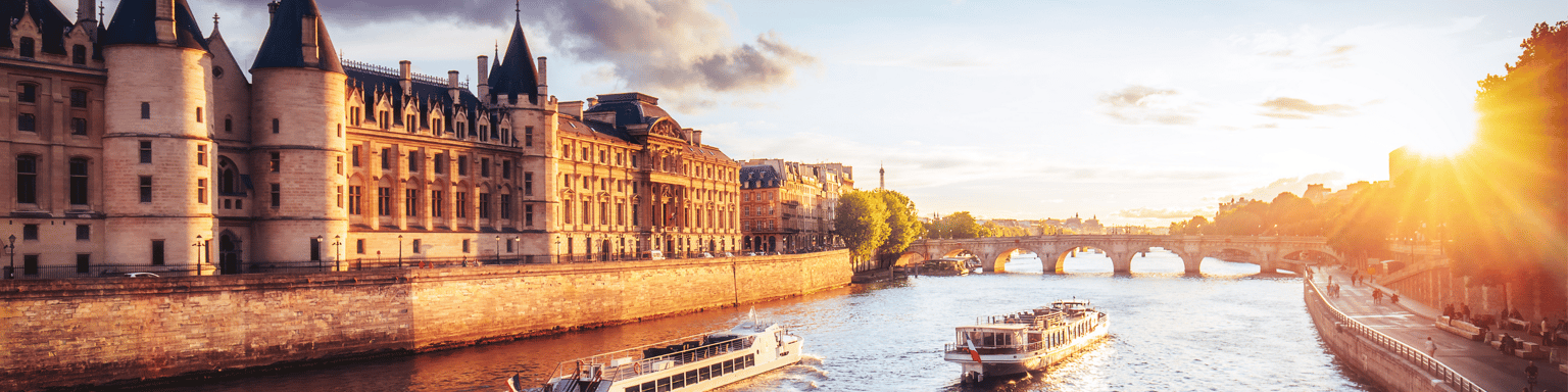 Dramatic sunset over river Seine in Paris, France, with Conciergerie and Pont Neuf.