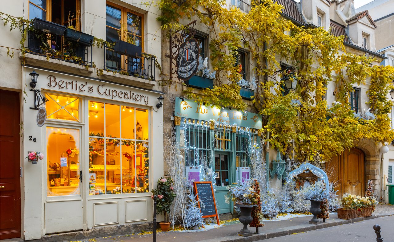 Cafes on a street in Paris decorated for Christmas