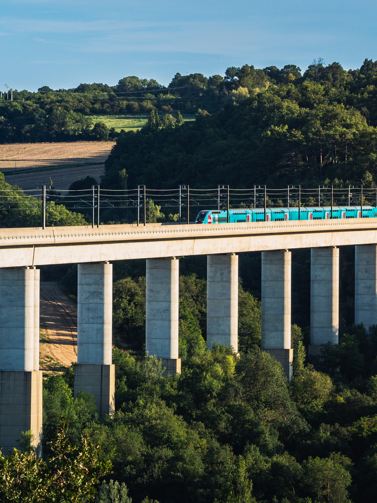 A train travelling over a bridge in France