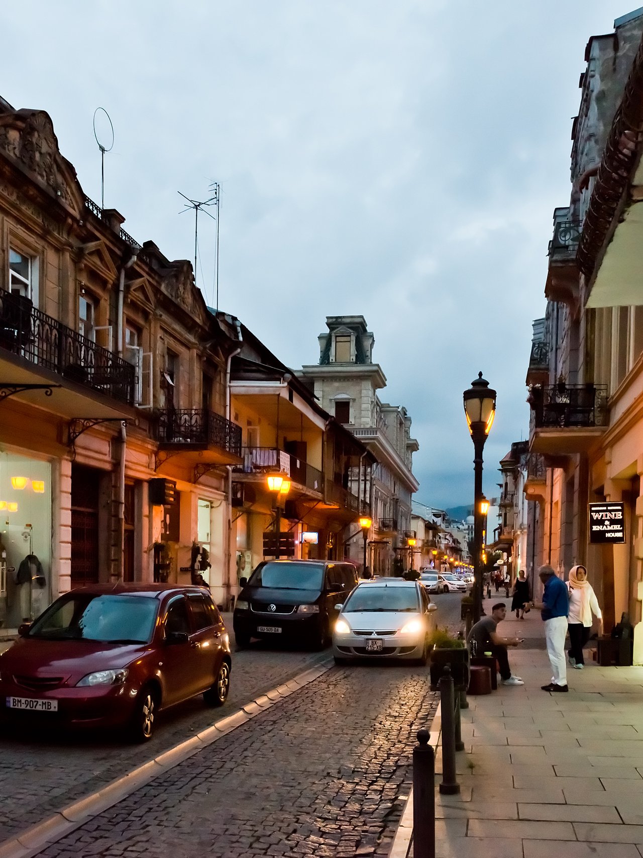 People and cars on a street in Batumi, Georgia at night