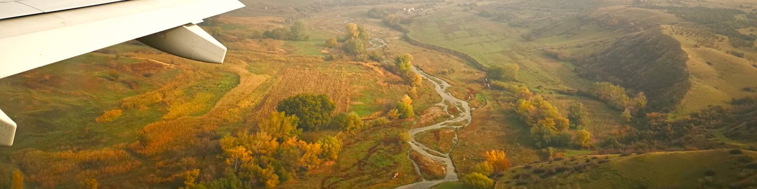 The Georgian countryside from a plane with the wing visible.
