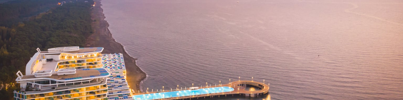 A beachfront resort with pool extending into the water in Shekvetili, Georgia.