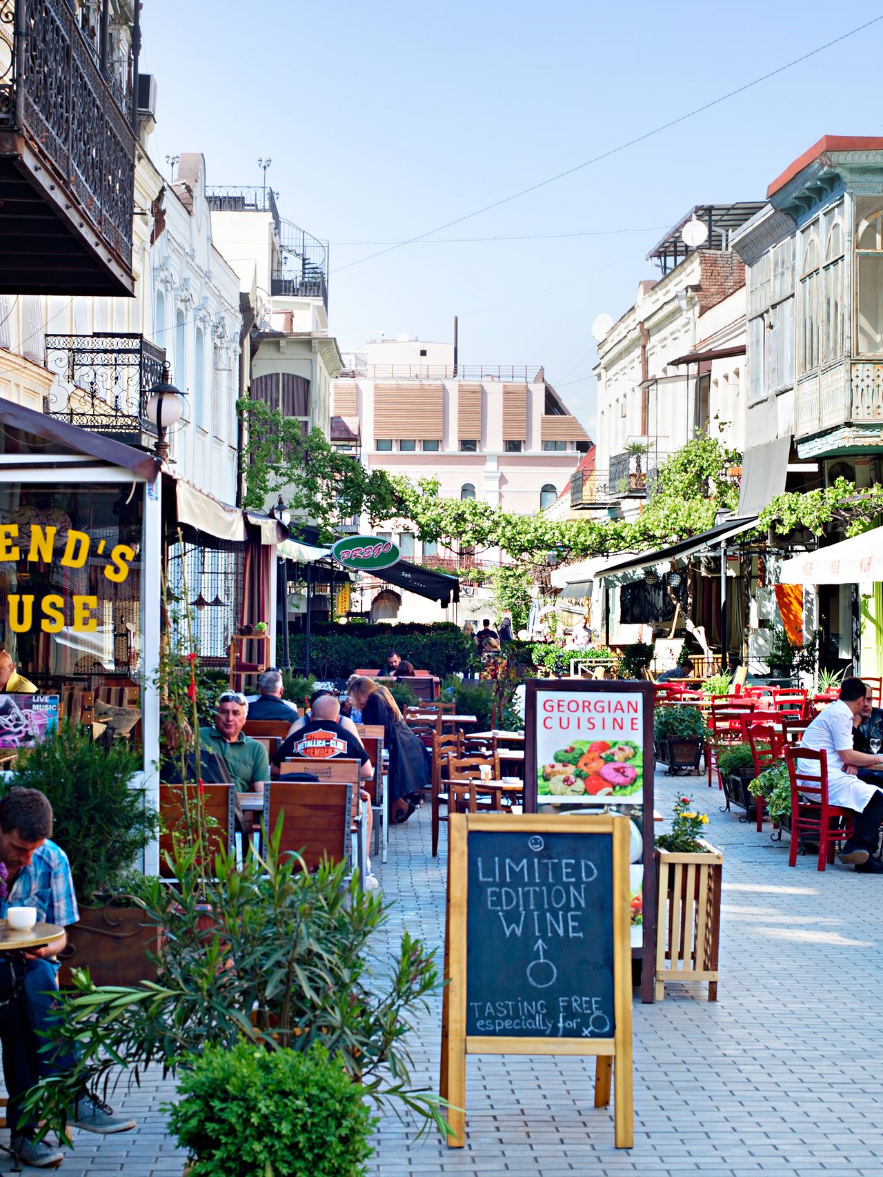 People sitting at outdoor restaurants in the Old Town of Tbilisi, Georgia.