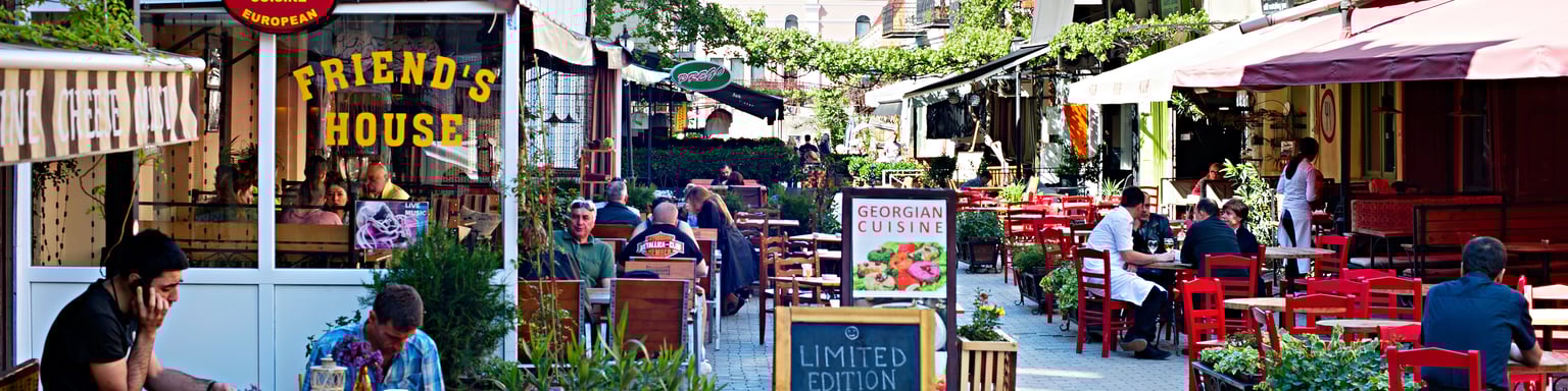 People sitting at outdoor restaurants in the Old Town of Tbilisi, Georgia.