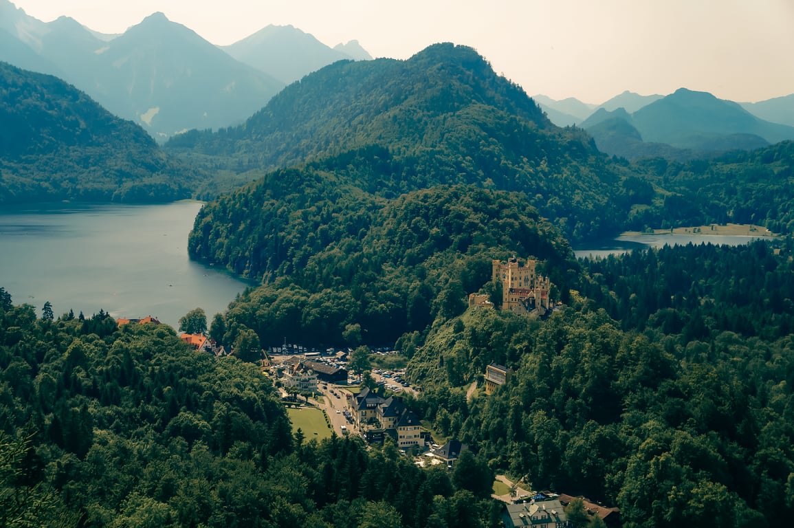 Looking down from Neuschwanstein Castle at the view of mountains and lakes