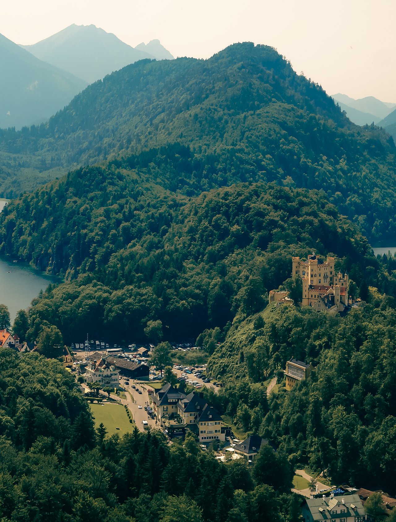 Looking down from Neuschwanstein Castle at the view of mountains and lakes