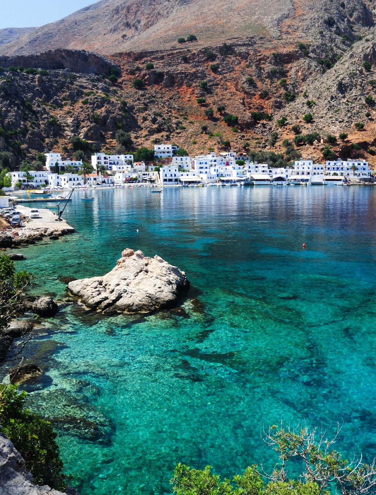 Blue water on Crete's southern coastline with the village of Loutro in the distance.