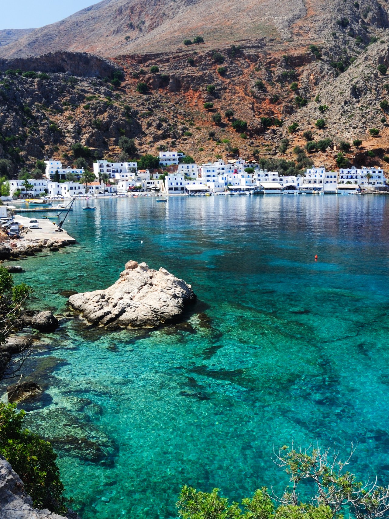 Blue water on Crete's southern coastline with the village of Loutro in the distance.