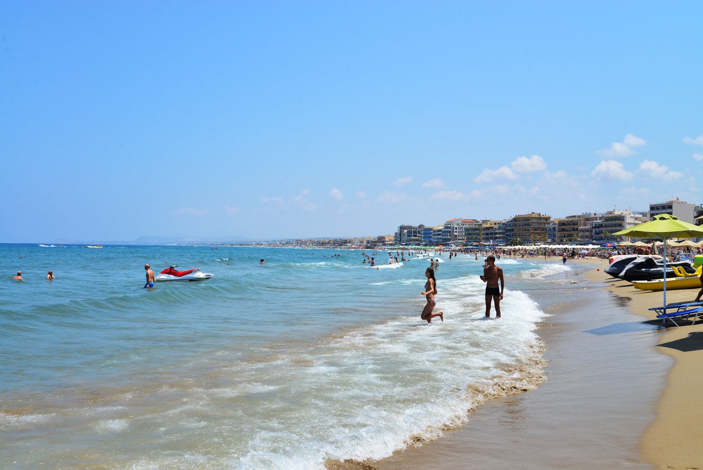 People in the water at Rethymnon city beach in Crete