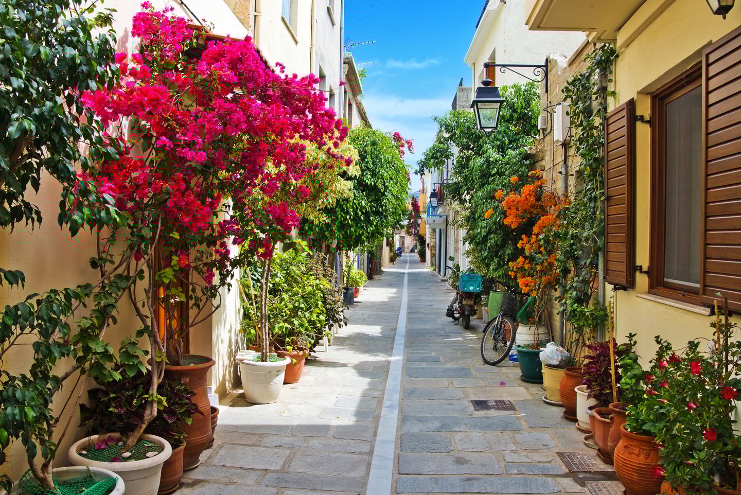 A pretty street lined with flowers in Rhythmno, Crete