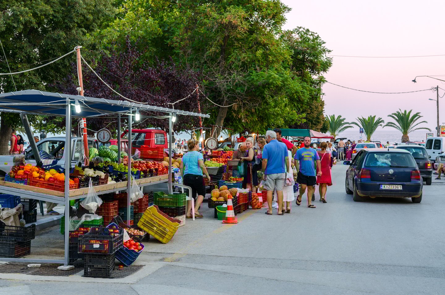 People bying fruit and vegetables at a market in Nea Kallikratia, Greece