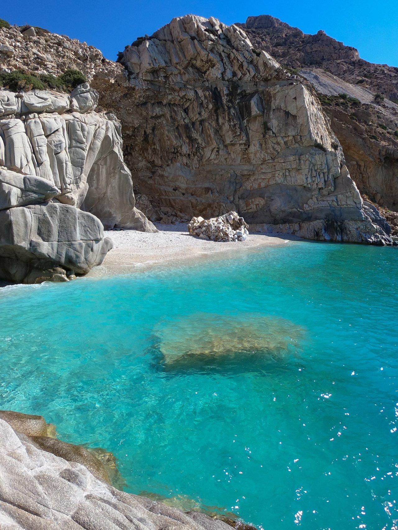 The beautiful Seychelles Beach, lined with rocks in Ikaria, Greece.