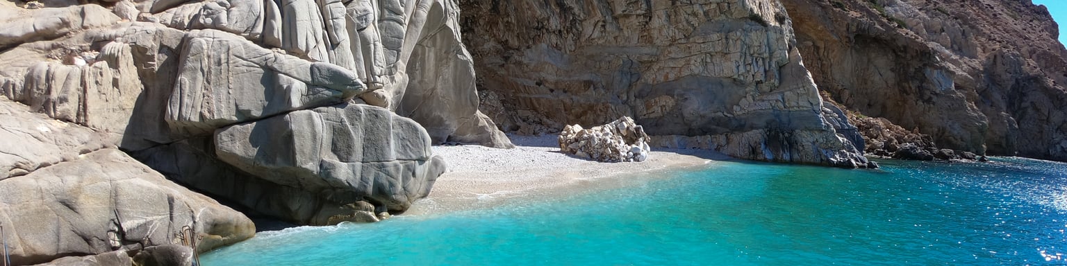 The beautiful Seychelles Beach, lined with rocks in Ikaria, Greece.