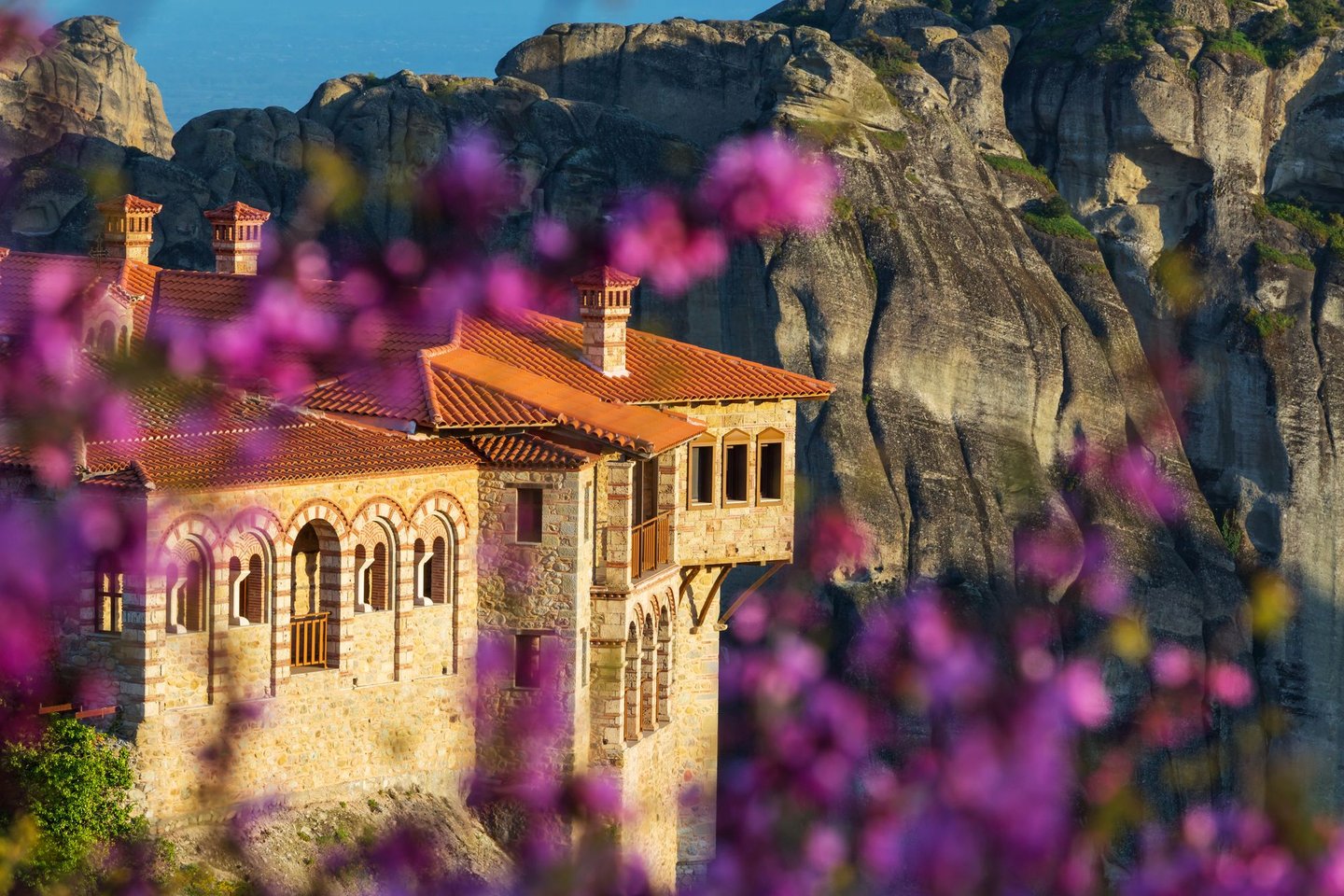 Looking at Varlaam Monastery between the blossoms in Meteora.