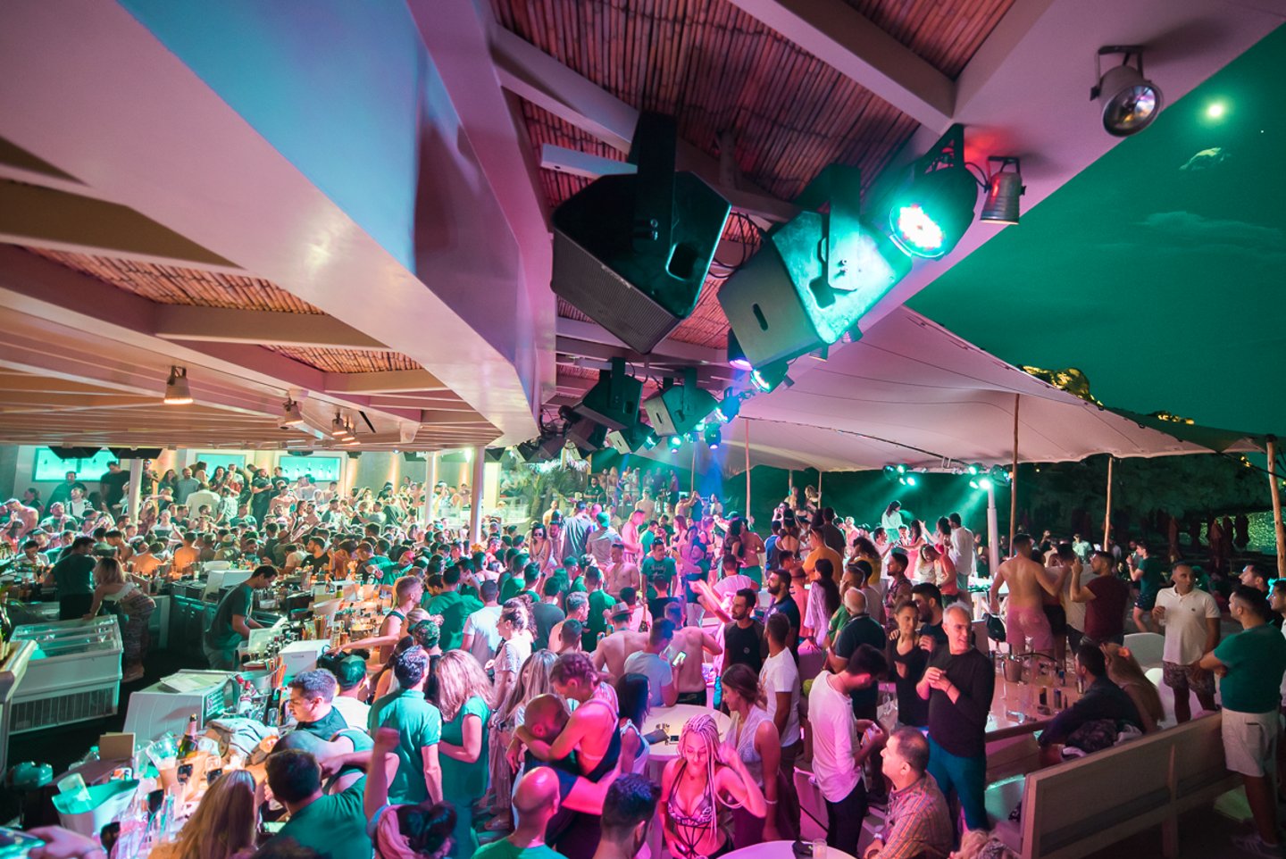 A crowded beach bar in Mykonos at night