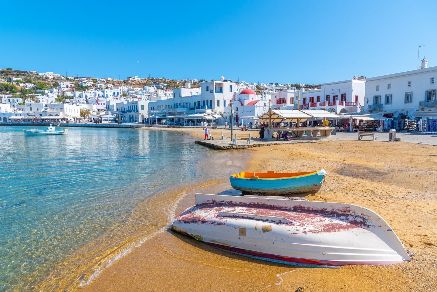 Boats on the sand with buildings in the background at the Old Port, Mykonos