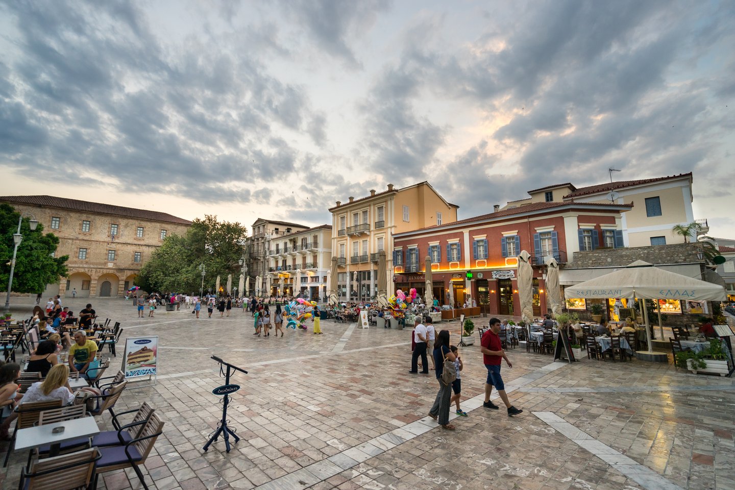 People walking and eating in Syntagma Square in Nafplio, Greece
